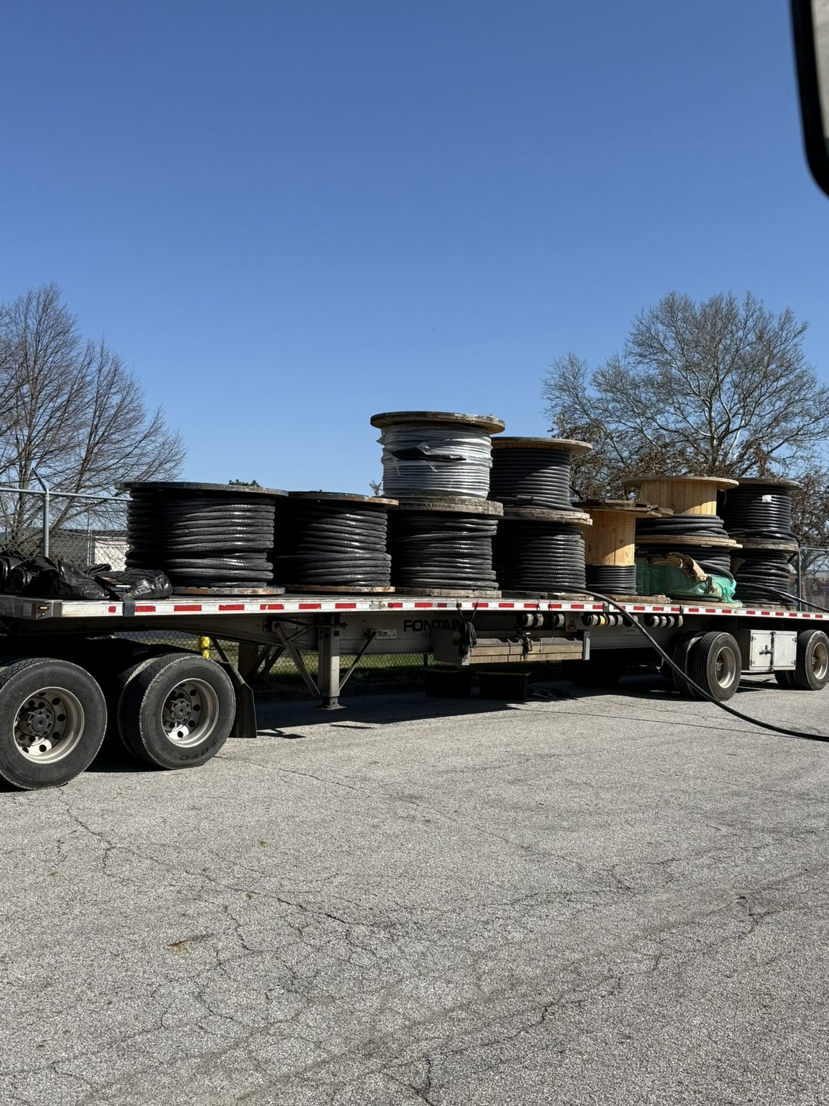 Wire spools loaded on a flatbed for pickup